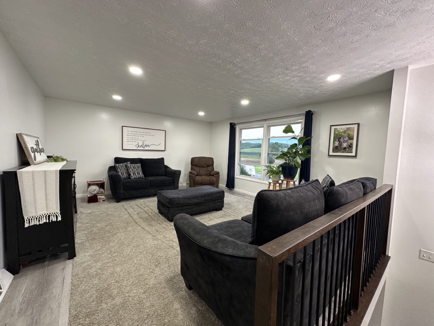 Living room with large windows framing the valley view