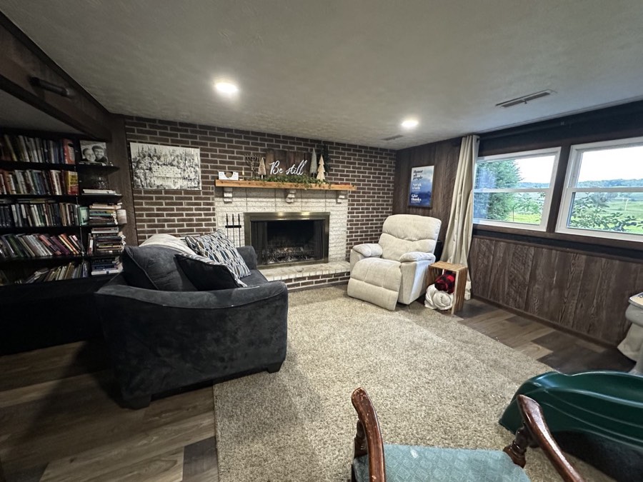 Lower-level family room with a brick wood-burning fireplace