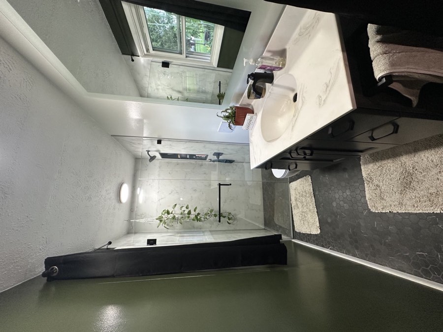 Primary bath with a heated tile floor and walk-in shower